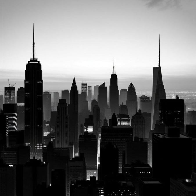 The iconic city skyline stands tall in this black-and-white wallpaper, featuring the famous skyscrapers that reach for the stars. Perfect for a desktop or mobile background to evoke a sense of urban sophistication and timeless architecture.