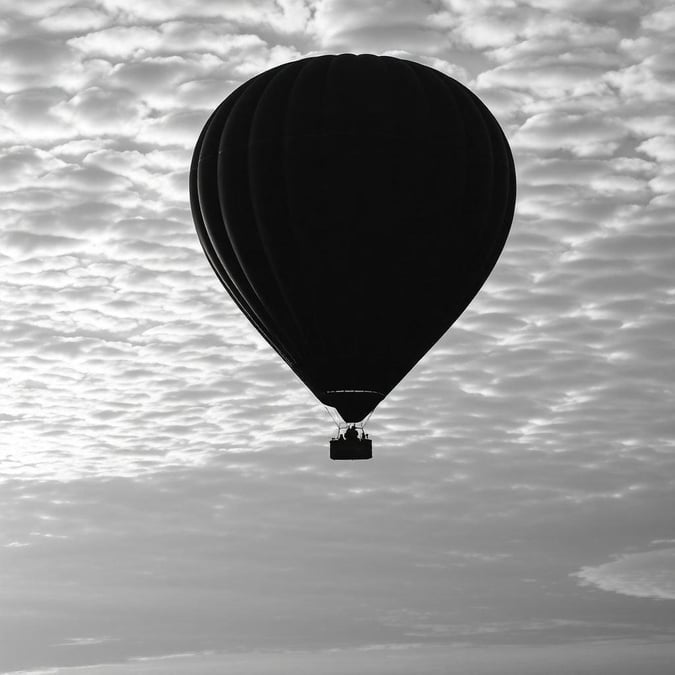 A serene black and white hot air balloon soaring through the sky, capturing the essence of simplicity and elegance.