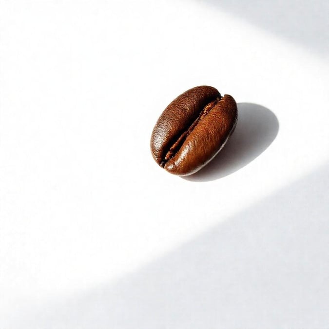 A simple yet elegant wallpaper featuring a single coffee bean, perfect for those who appreciate the beauty of minimalism.