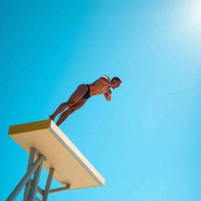 This captivating sports scene shows an athlete poised on the edge of a diving board, ready to leap into action. The vibrant blue sky forms a stunning backdrop for this thrilling moment.