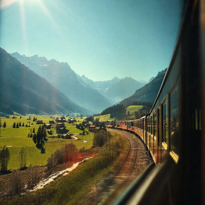 Experience the thrill of a train journey through breathtaking mountain landscapes.