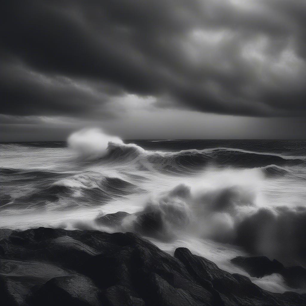 A dramatic black and white view of the ocean in turmoil, with crashing waves creating a sense of nature's raw power.